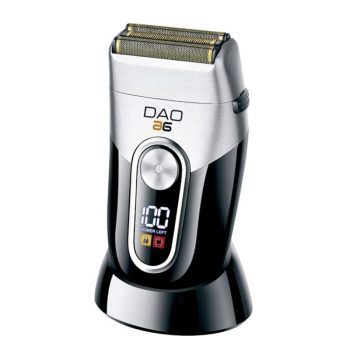 Afeitadora eléctrica de alta calidad color plateado y negro con cabezal de láminas doradas, botón frontal y pantalla digital que indica batería completa, apoyada en su base de carga ergonómica.