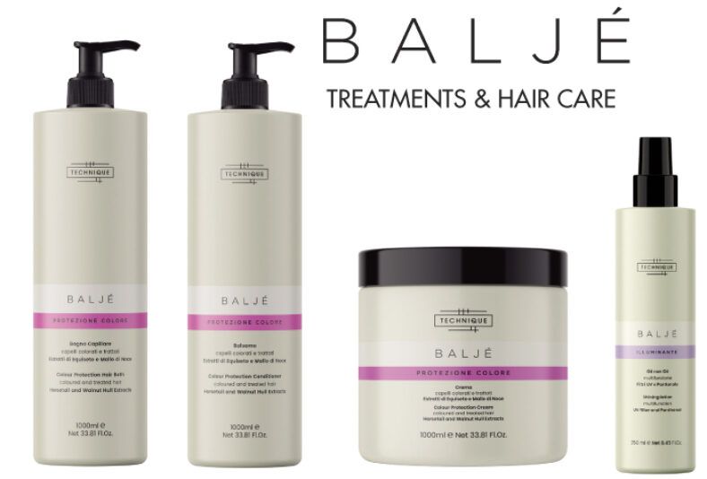 Conjunto de productos de cuidado capilar Baljé para peluquería que incluye dos botellas dispensadoras (champú y acondicionador), una mascarilla en tarro y un spray iluminador con diseño minimalista en tonos crema y banda rosa.