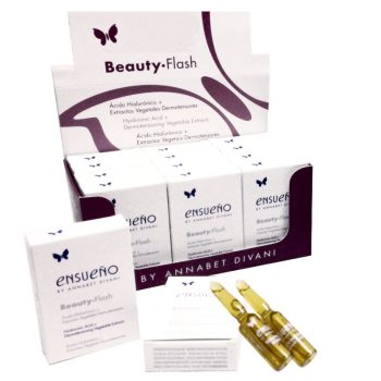 Expositor con cajas blancas de suero facial Ensueño Beauty-Flash y dos ampollas doradas en primer plano, con logotipo de mariposa visible y diseño pensado para mostrarse en peluquería.