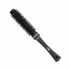 Cepillo redondo negro para peinar y dar volumen con barril cilíndrico perforado, cerdas densas y mango ergonómico con orificio para colgar, de apariencia profesional y alta calidad.