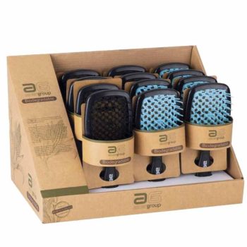 Caja expositora con múltiples cepillos acolchados de mango negro y almohadilla azul y negra en embalaje de cartón biodegradable, listos para uso en peluquería con resultado profesional garantizado.