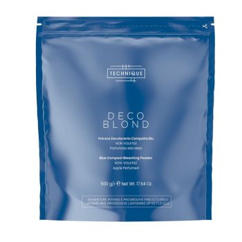 Bolsa sellada azul con tipografía blanca que muestra la marca Technique y el nombre Deco Blond, indicando en varios idiomas "Blue Compact Bleaching Powder", "non‑volatile" y "apple perfumed", diseñada para uso profesional y atractiva para el distribuidor.