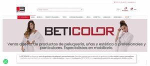 Banner de la tienda online BETICOLOR con logo grande en el centro, dos modelos femeninas a ambos lados, menú y buscador en la cabecera y texto promocional sobre venta directa de productos de peluquería, uñas y estética a profesionales y particulares.