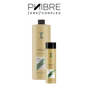 Dos envases dorados de champú reestructurante con tapas negras y detalles verdes, dispuestos uno grande y uno pequeño sobre fondo blanco, presentando un diseño limpio y orientado a uso profesional.