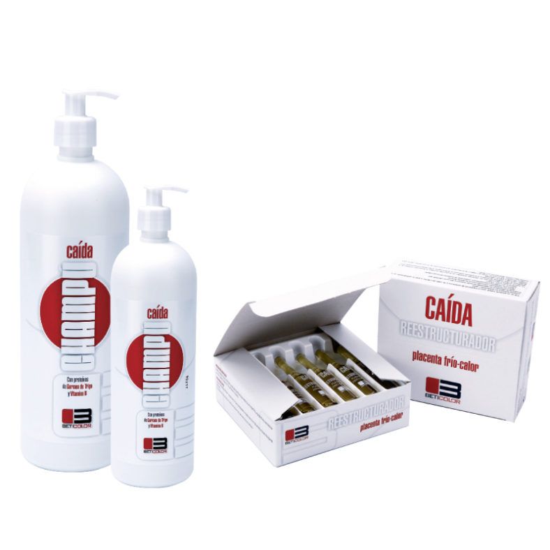 Dos frascos blancos con dispensadores y una caja abierta con ampollas de reestructurador capilar etiquetado CAÍDA, colocados sobre fondo blanco, imagen pensada para uso profesional y con un diseño especial.