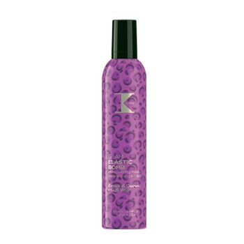 Envase aerosol alto de color morado con estampado circular y tapa negra, etiquetado como espuma/mousse para peinado sobre fondo blanco, pensado para peluquería.